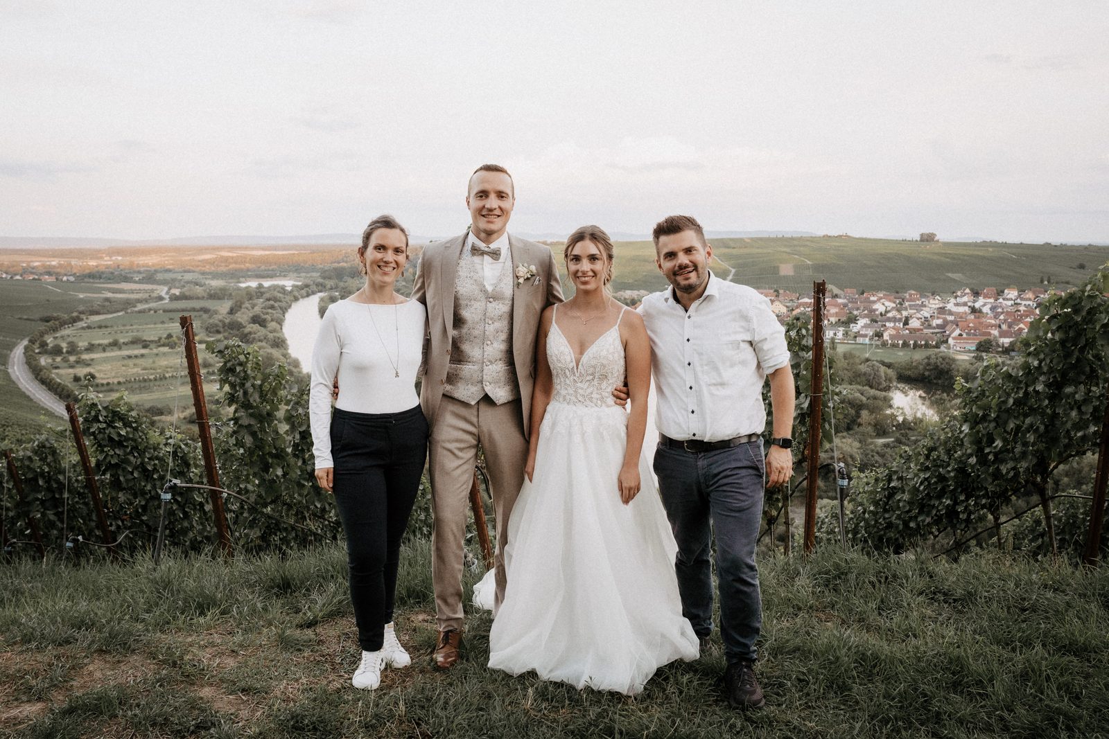 Gruppenbild mit Freunden in den Weinbergen, dahinter der Blick über die Mainschleife