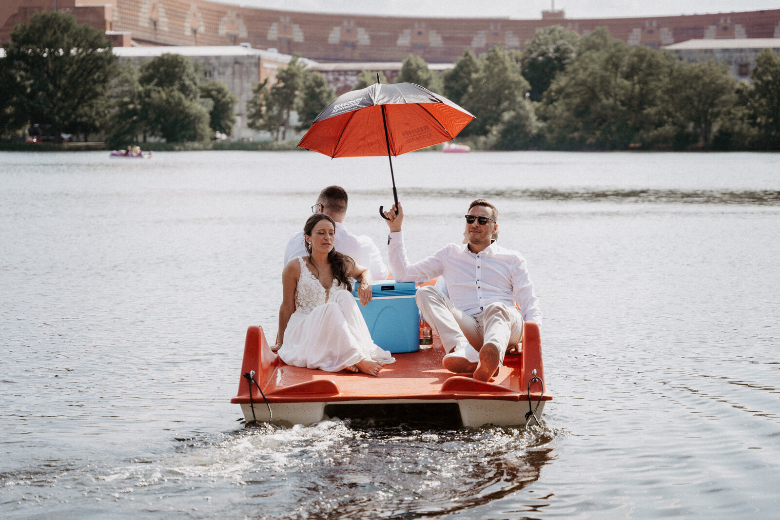Tretboot mit Braut und rotem Schirm auf dem Dutzendteich
